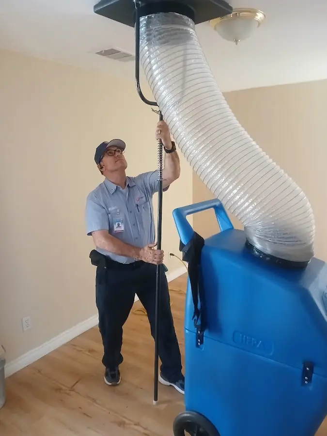 Furnace Tune-Up technician using HEPA equipment in Coral Hills